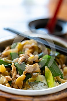 fast food of fried slices of pork and pickled mustard with bowl of soup vertical composition