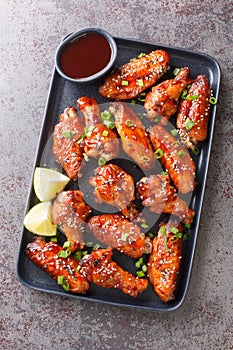 Fast food fried Sticky Hoisin Wings closeup on the plate. Vertical top view