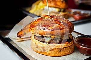 Fast food hamburger and french fries on a metal plate