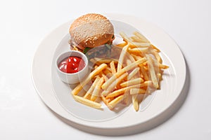 Fast food hamburger and french fries on a white plate