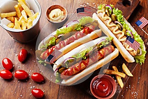 Fast food from hot dog with sausage and fries decorated USA flag on 4th july top view. Table setting on american independence day.