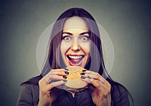 Fast food is my favorite. Woman eating a hamburger