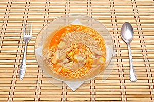 Fast food noodles with fork and spoon