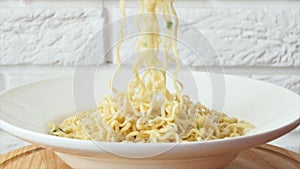 Fast food pasta close-up. Instant noodles in a soup bowl with Chinese chopsticks.