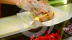 Fast food, prparing sandwich in transparent glowes