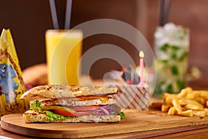 Fast food served table for company of friends. burger, french fries at birthday served table