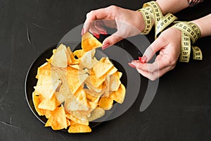 Fast food snacks bad diet habit woman eating chips