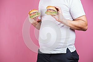 Fast food and weight gain. fat man with burgers