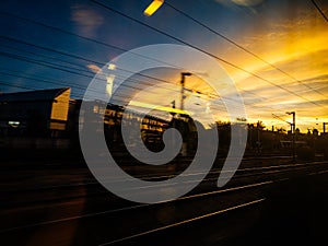 Fast French TGV train and Parisian cityscape sunset