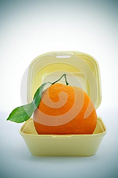 Fast fruit, an orange in a foam food container