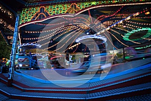 Fast funfair ride carousel at the christmas market, long exposu