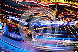 Fast funfair ride carousel at the christmas market, long exposure with blurred motion, abstract background, copy space