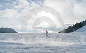 Fast going skier boy ride down the mountain hill. Active winter sport concept image