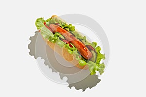 Fast and healthy snack food in menu for client. Delicious hot dog with grilled sausage, salad, cucumber and tomato with