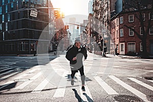 Fast man runner wearing sportswear preparing for marathon