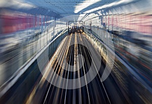 Fast motion zoom effect in a tunnel with train tracks