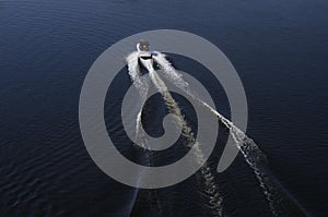 Fast motor boat on a dark water surface