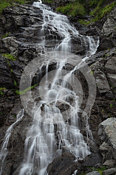 Fast mountain waterfall in vertical orientation