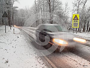 Fast moving car brakes in a snow storm