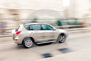 Fast moving car on the city roadway in motion blur