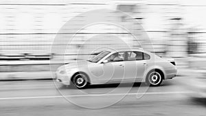 Fast moving car on the city roadway in motion blur