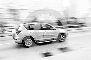 Fast moving car on the city roadway in motion blur
