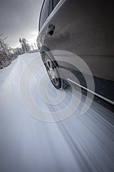 Fast moving car on a  snowy road