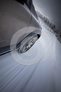 Fast moving car on a  snowy road