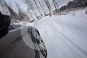 Fast moving car on a winter snowy road