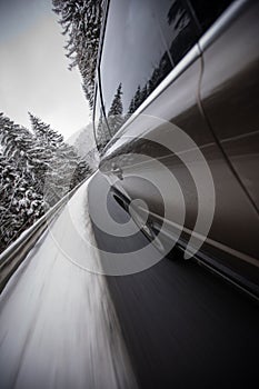 Fast moving car on a wintersnowy road