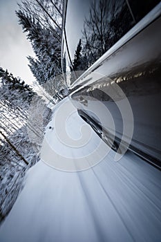 Fast moving car on a wintersnowy road