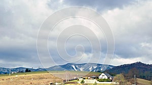 Fast moving clouds over house on the top of the hill. Landscape timelapse over Banska Bystrica, Slovakia, Central Europe. C