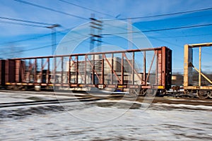 Fast Moving Empty Lumber Car Across Railway Tracks