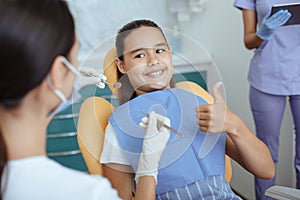 Fast and painless dental treatment in modern clinic with medical team