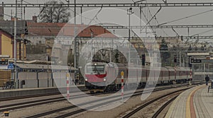 Fast passenger train with red modern electric engine in Ilava station