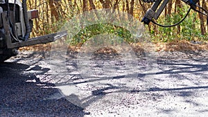 Fast road surface repair process by asphalt, bitumen spraying. spray incjection machine, patching pothole with hot