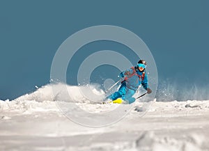 Fast skier downhill at ski resort photo