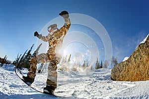 Fast snowboarder downhill in powder.