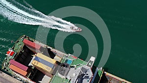 Fast Speed Security Patrol Boat Near container ship, Aerial View