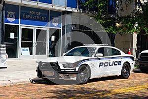 Fast sporty cop car in front of Police Department station house