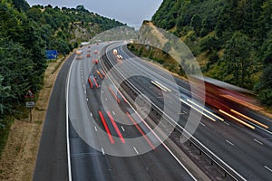 Fast traffic speeding along the M40 motorway in Buckinghamshire. Light trails from long exposure.