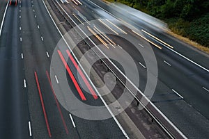 Fast traffic speeding along the M40 motorway in Buckinghamshire. Light trails from long exposure.