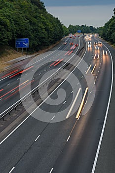 Fast traffic speeding along the M40 motorway in Buckinghamshire. Light trails from long exposure.