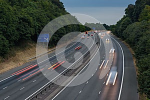 Fast traffic speeding along the M40 motorway in Buckinghamshire. Light trails from long exposure.