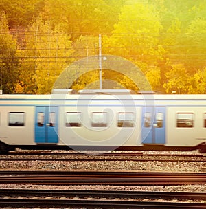 Fast train against Autumn forest