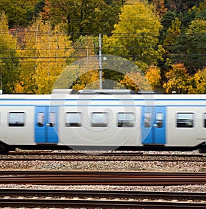 Fast train against Autumn forest