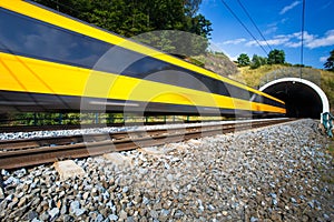 Fast train passing through a tunnel on a lovely summer day