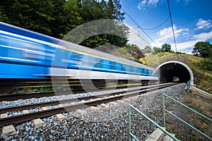 Fast train passing through a tunnel on a lovely summer day