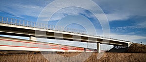 Fast train passing under a bridge on a lovely summer day