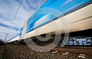 Fast train passing under a bridge on a lovely summer day